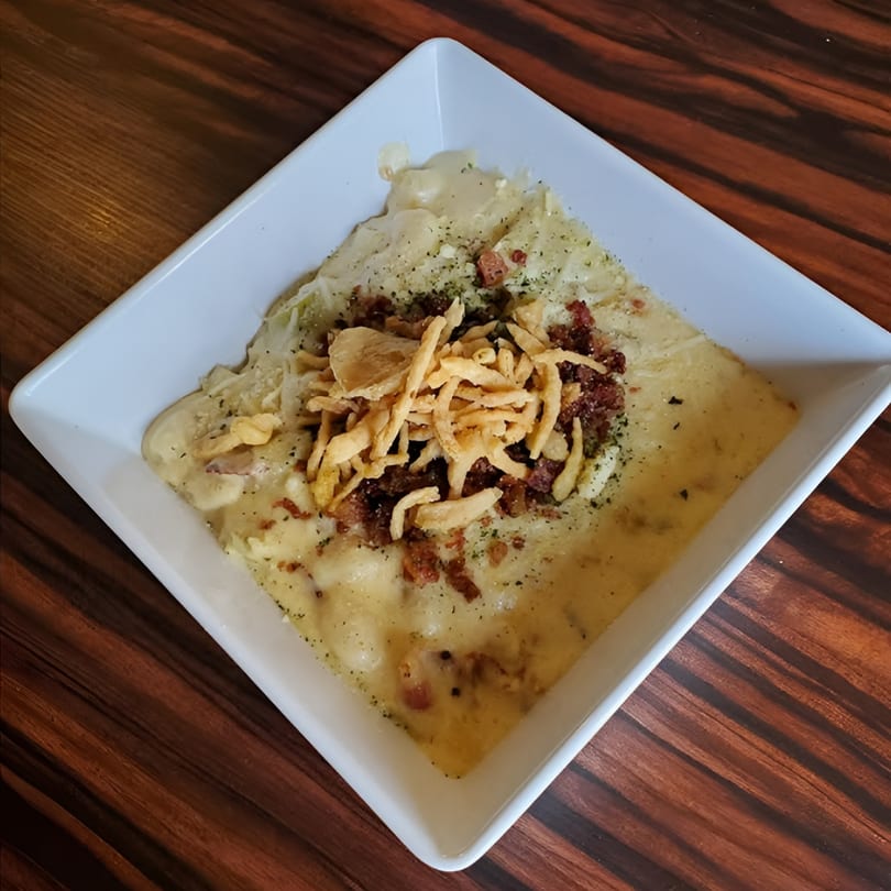 Elmwood Inn's creamy mac and cheese topped with crispy fried onions and bacon bits.